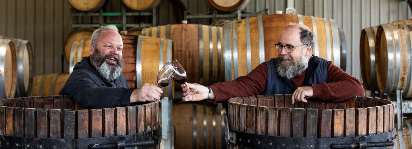 2 men inside a barrel toasting at Hayes Family Wines